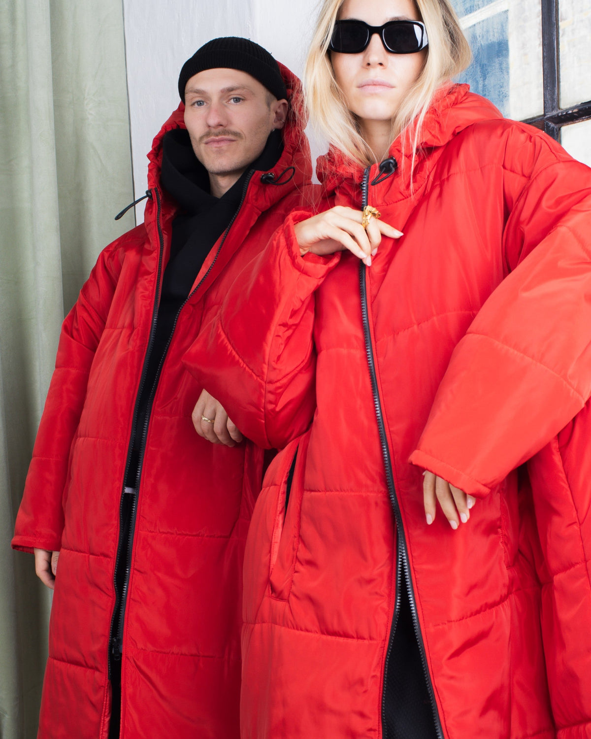 Two people wearing green Sittingsuits indoors